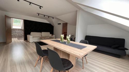 索利纳Dom - Apartamenty Prestige - opcja jacuzzi i sauna的客厅配有木桌和椅子