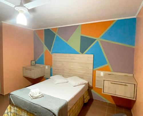 圣卡洛斯中央公园住宅酒店的一间卧室设有色彩缤纷的墙壁和床