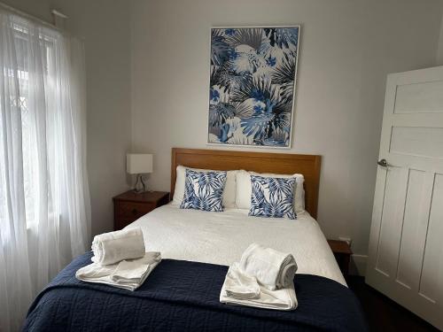 阿德莱德Glenelg House的一间卧室配有带毛巾的床