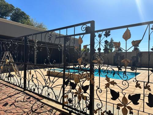 约翰内斯堡Sekgome Resort的院子内带游泳池的铁栅栏