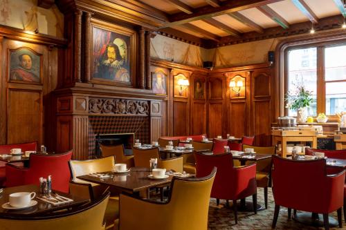 巴黎Hotel Etats Unis Opera的餐厅拥有木墙和桌椅