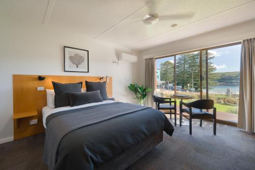 坎贝尔港阿德湖汽车旅馆的一间卧室配有一张床和一张桌子及椅子