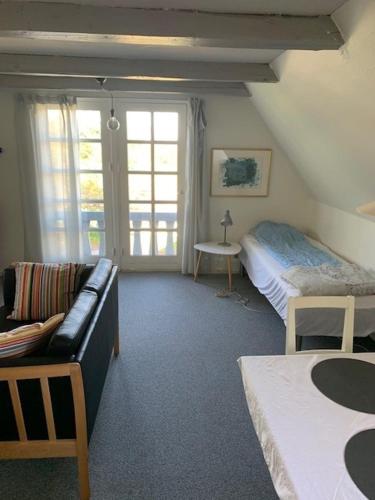 赫尔辛厄Dyrlundgaard tilbyder charmerende ferielejlighed.的客厅配有沙发和1张床