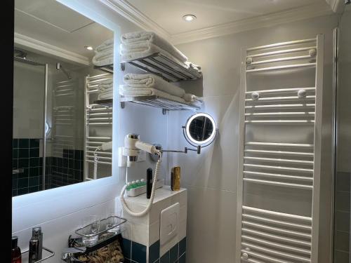 巴黎Appartement Montmartre Sacré Cœur的浴室配有盥洗盆、镜子和毛巾