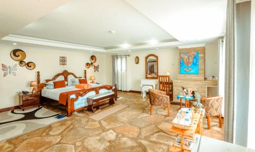 KinigiIngagi Park View Lodge的一间卧室设有一张床和一间客厅。