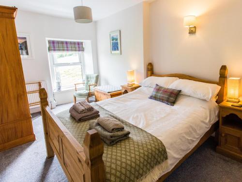 布莱奈费斯蒂尼奥格Moelwyn View Cottage的一间卧室配有一张床,上面有两条毛巾