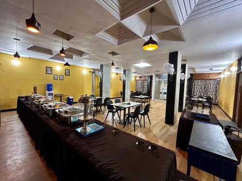 海得拉巴New Hotel Suhail的一间在房间内配有桌椅的餐厅