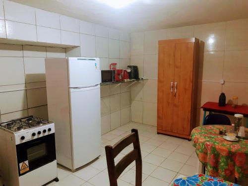 累西腓Lê'Frevo Pernambucano Hostel的厨房配有炉灶、冰箱和桌子