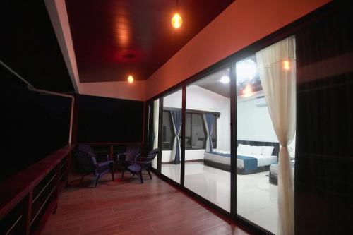 San PedrilloEden Corcovado的客厅,带一张床和玻璃门的房间