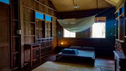 清道Traditional Lanna house near hot spring的配有床和蚊帐的客房