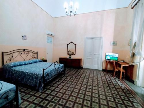 贝尔帕索Etna的一间卧室配有一张床、一张书桌和一台电视