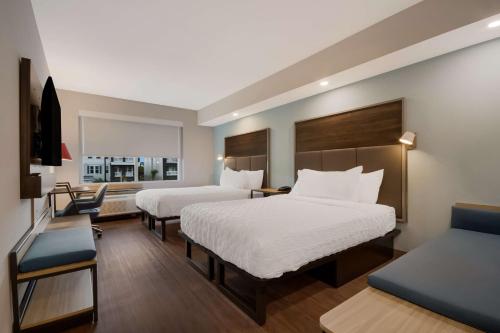 德斯坦Tru By Hilton Destin的酒店客房,设有两张床和一张沙发