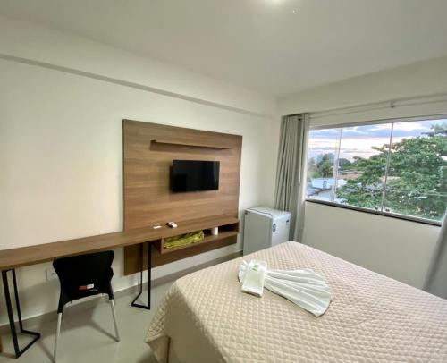 泰谢拉迪弗雷塔斯Hotel Skalla的一间卧室配有一张床、一张书桌和一台电视