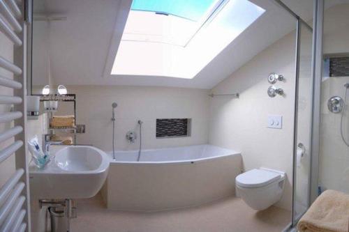 米滕瓦尔德Sonnentau -909-的带浴缸、卫生间和天窗的浴室