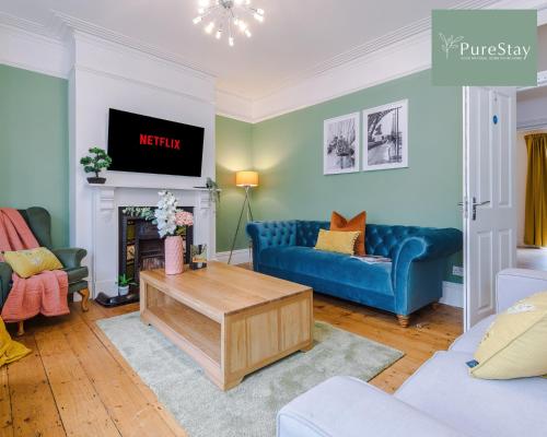 巴斯Incredible Five Bedroom House By PureStay Short Lets & Serviced Accommodation Central Bath With Parking的客厅配有蓝色的沙发和电视