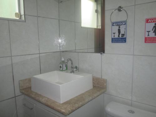 波苏斯-迪卡尔达斯Recanto das Rosas的浴室设有白色水槽和镜子