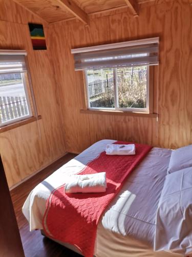 Bahía MurtaSol de la Patagonia Bahía Murta的一间卧室配有一张床,上面有两条毛巾