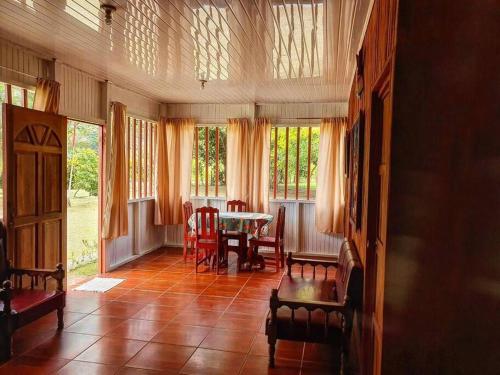 希门尼斯港Villa Montezuma Corcovado的客厅配有桌椅和窗户。