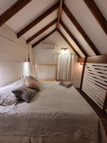 玛德琳港La Cabaña的阁楼上的卧室配有一张大床