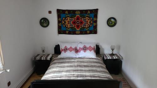 丰杜摩尔多瓦Casa Rustik Bucovina的卧室配有一张挂壁挂毯的床