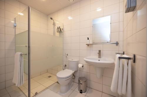 科威特Riggae Tower Hotel的白色的浴室设有卫生间和水槽。