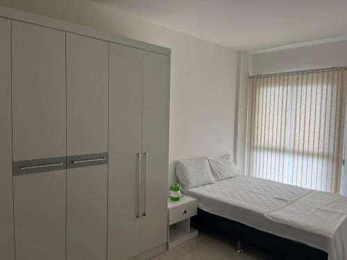 曼加拉蒂巴Apartamento Rio Marina Resort的一间卧室配有床和白色橱柜