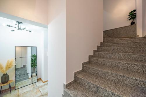 普罗夫迪夫Three Lilies Apartments的房屋内的楼梯,有白色的墙壁和楼梯