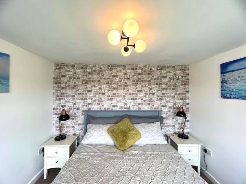 多切斯特Tumbleweed 2的一间卧室配有一张带2个床头柜和2盏灯的床。