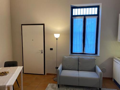 米兰Cozzi Apartment的客厅配有椅子和窗户