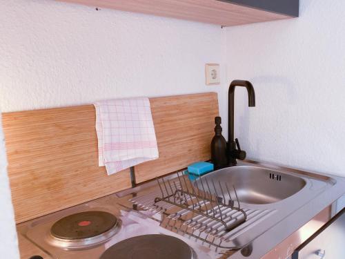 诺伊斯Central Apartment Rhein Neuss-Düsseldorf Messe的厨房水槽旁设有碗碟干燥架