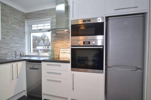 特伦Ideally Located Modern Flat的厨房配有不锈钢烤箱和冰箱。