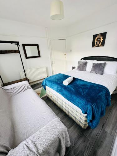 WykenSpacious Town House的一间卧室配有两张带蓝白色床单的床
