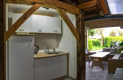 斯姆勒尼科Glamping with a view的厨房配有白色橱柜、桌子和庭院。