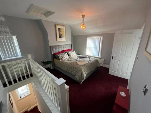 锡福斯The Townhouse in Waterloo sleeps 4的卧室配有带红地毯和白色门的床