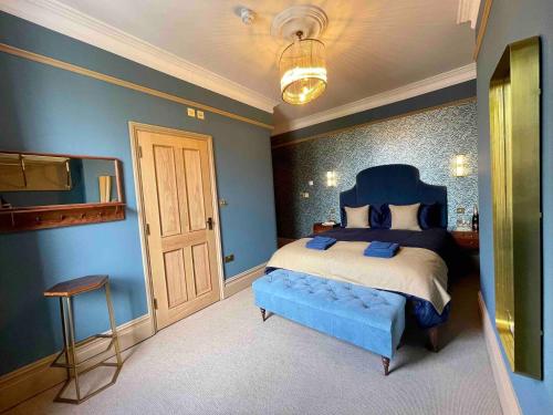 KentThe Bedford Inn的一间蓝色的卧室,配有一张床和一台电视