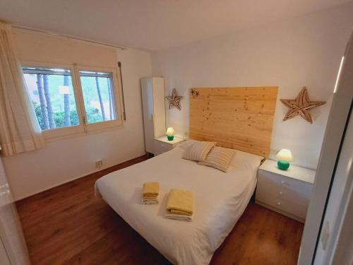帕尔斯Apartamento con piscina cerca de la playa的一间卧室配有一张带两张黄色毛巾的床