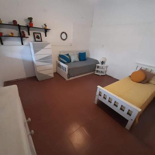卡皮亚德尔德尔蒙特OMA- Casa Temporaria的小房间设有两张床和一张床。