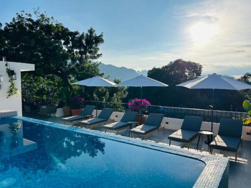 迪坡斯特兰Tatala Hotel & Garden的一个带躺椅和遮阳伞的游泳池