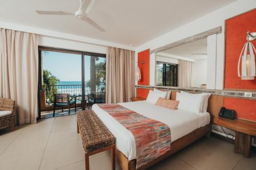弗利康弗拉克塔马兰高尔夫&Spa精品酒店的一间卧室配有一张床,享有海景