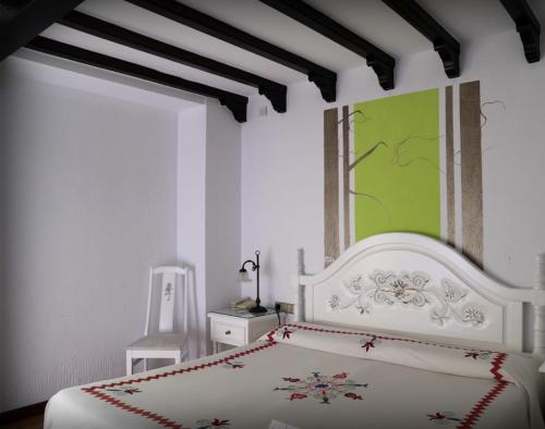 拉阿贝尔卡多纳特瑞萨酒店的卧室配有白色的床和绿色绘画
