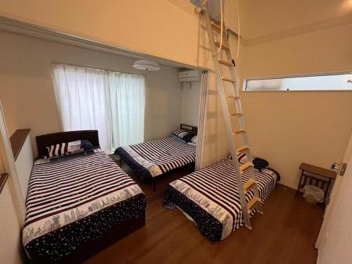 千叶Maisonette Hanazono - Vacation STAY 97278v的客房设有两张双层床和梯子