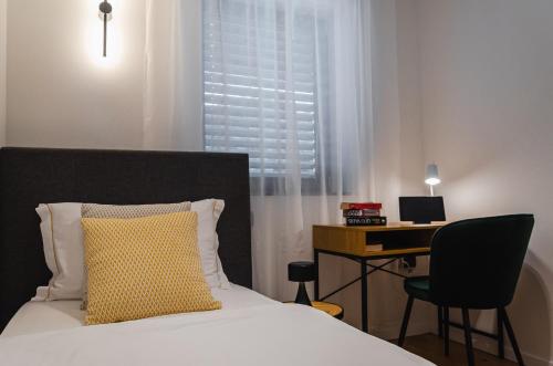 斯洛文尼亚格拉代茨Apartma Vila Center LUX的一张黄色枕头的床和一张桌子
