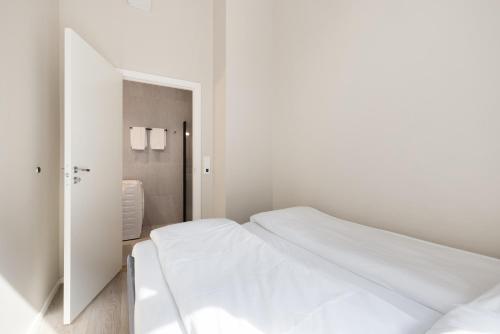 奥斯陆Maya Apartments - Parkveien的白色的卧室配有白色的床和镜子