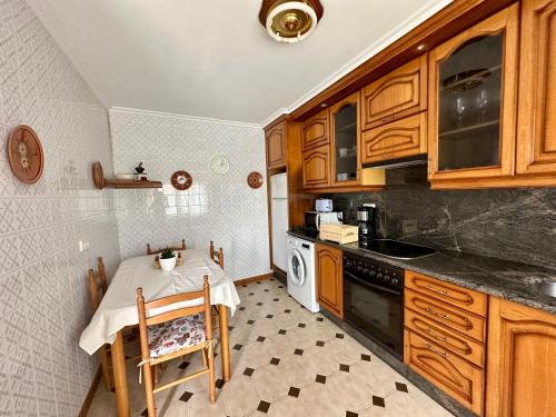 拉科鲁尼亚CasaLola - Corme Porto的一间带桌子和炉灶的小厨房