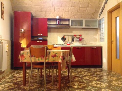 莫诺波利Sea Home的厨房配有桌椅和红色橱柜