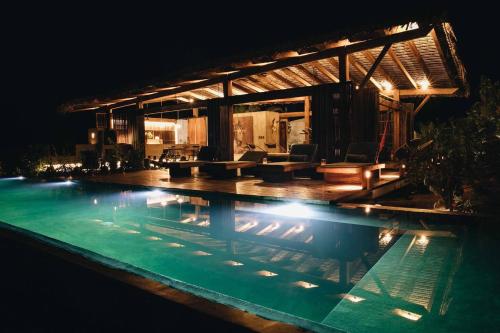 RecadoCasa Altanera的夜间游泳池与房子