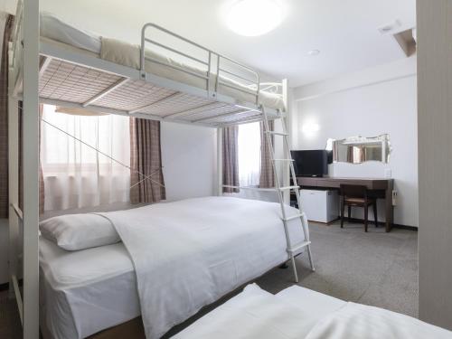 Sukagawa须贺川永国际酒店的一间卧室配有两张双层床和一张书桌