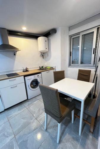 贝尔加Apartamento céntrico económico en Berga P1的厨房配有白色的桌椅