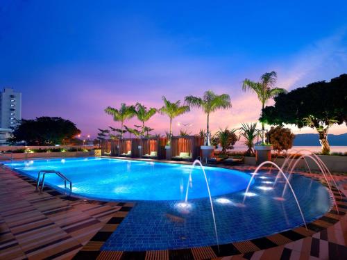 哥打京那巴鲁京那巴鲁凯悦酒店的一个带喷泉和棕榈树的游泳池
