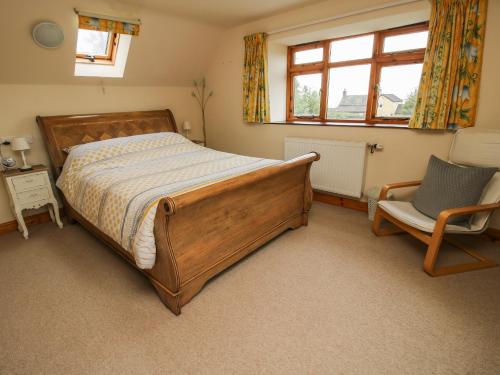 什鲁斯伯里Rowan Cottage的卧室配有床、椅子和窗户。